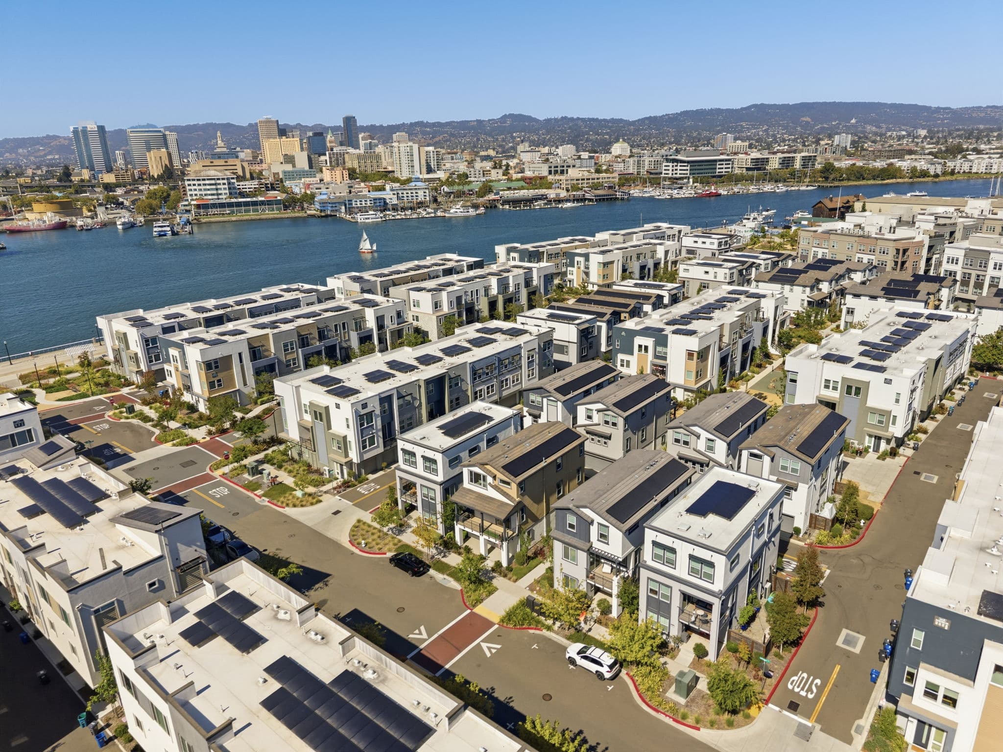 Aerial of Alameda's waterfront community with the Oakland skyline