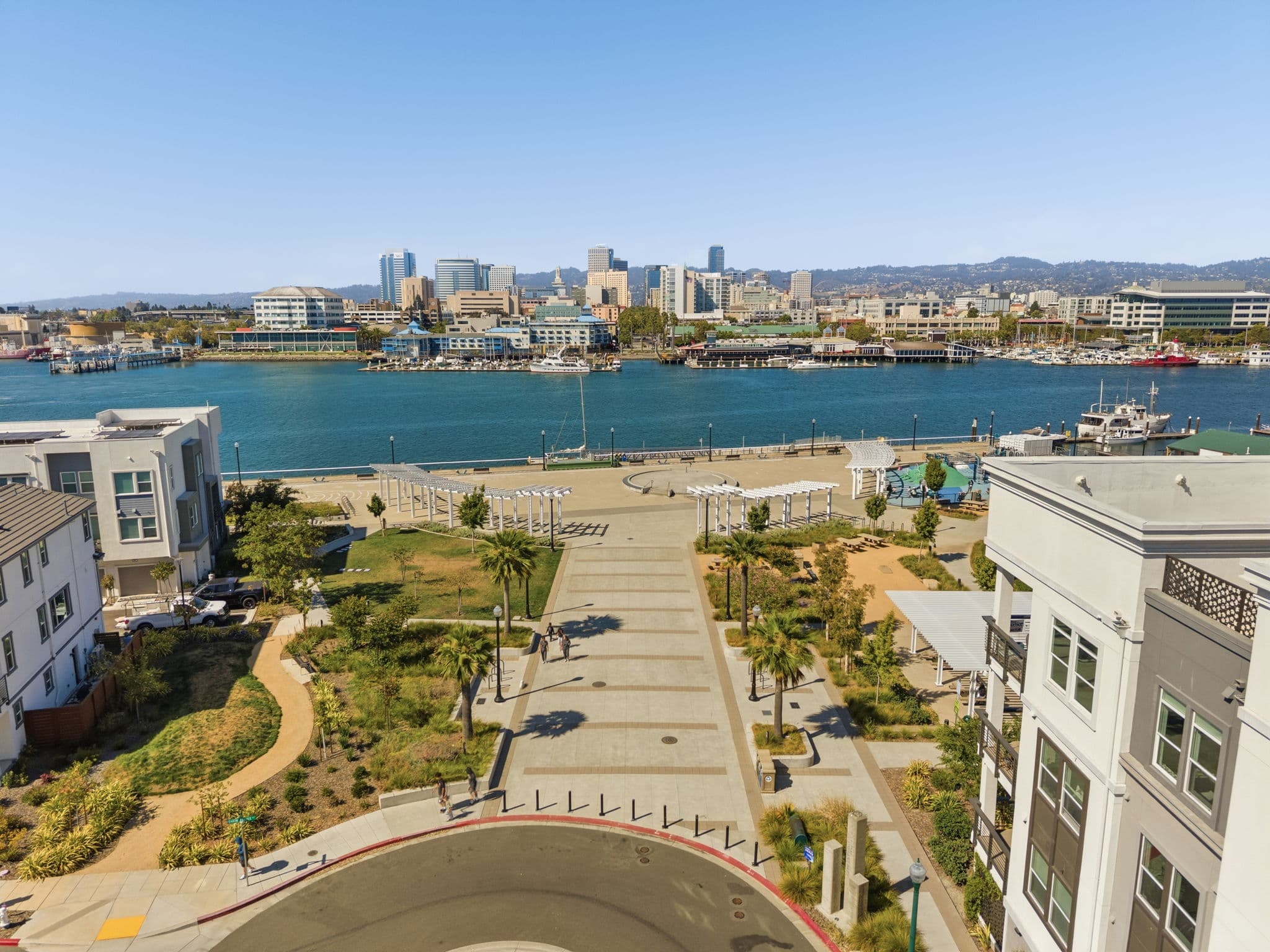 Aerial down the landscaped central paseo to the waterfront